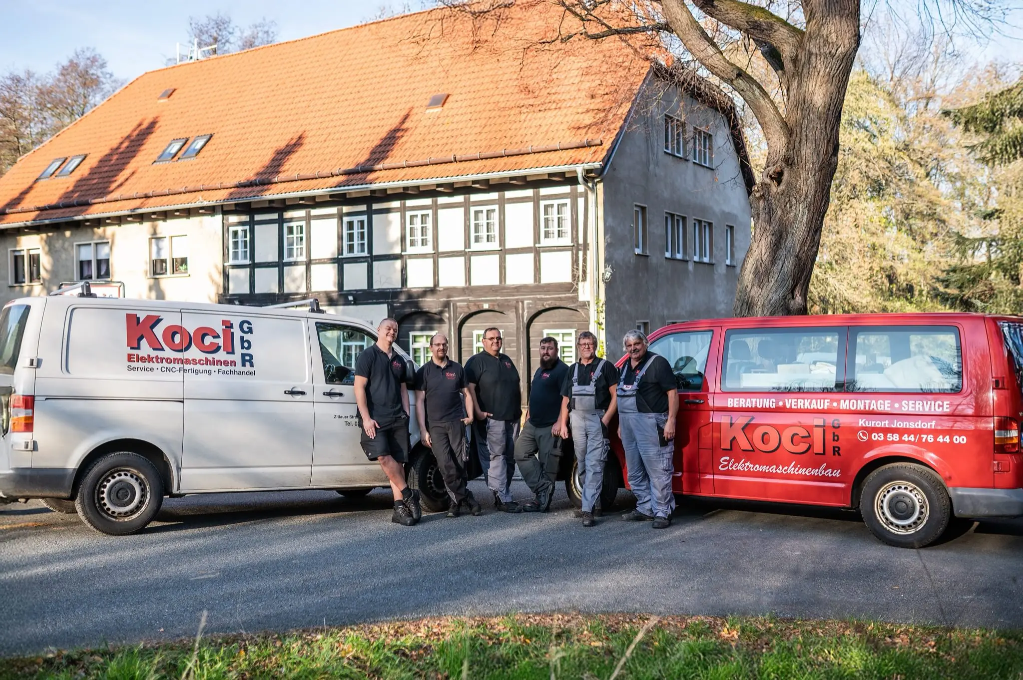 KOCI service team and vehicles outside the company building